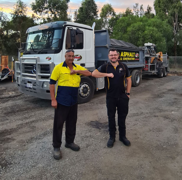 Pothole People Qld stood in front of asphalt truck on construction site