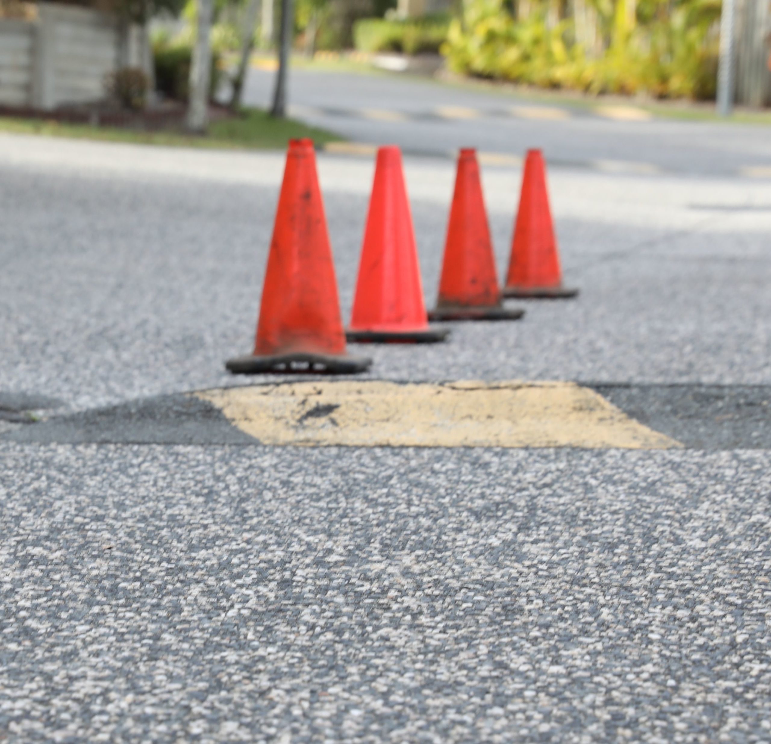 Residential street with cones laid out near a speed bump